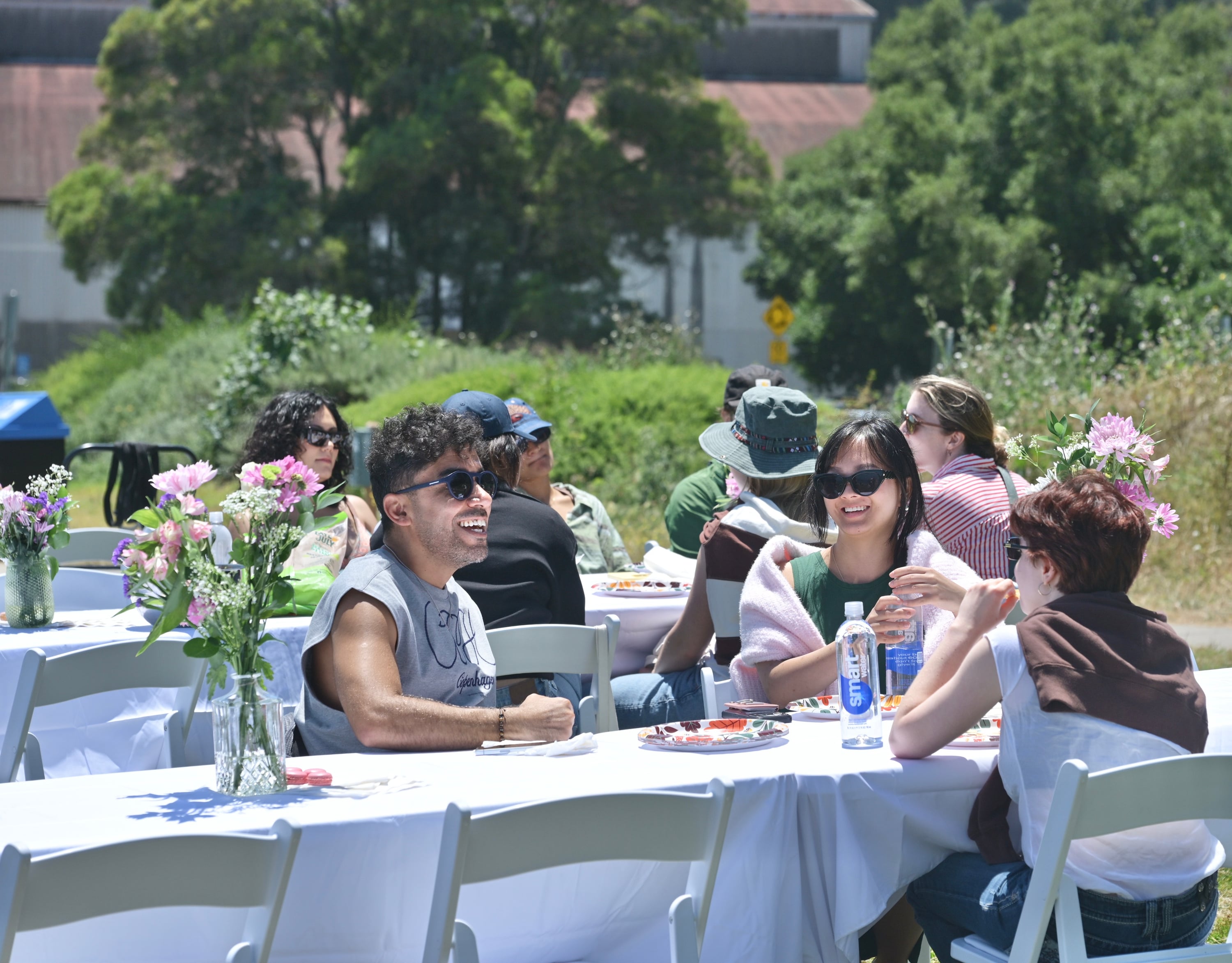 Guests enjoying a sunny outdoor gathering at a Table Talk table setup